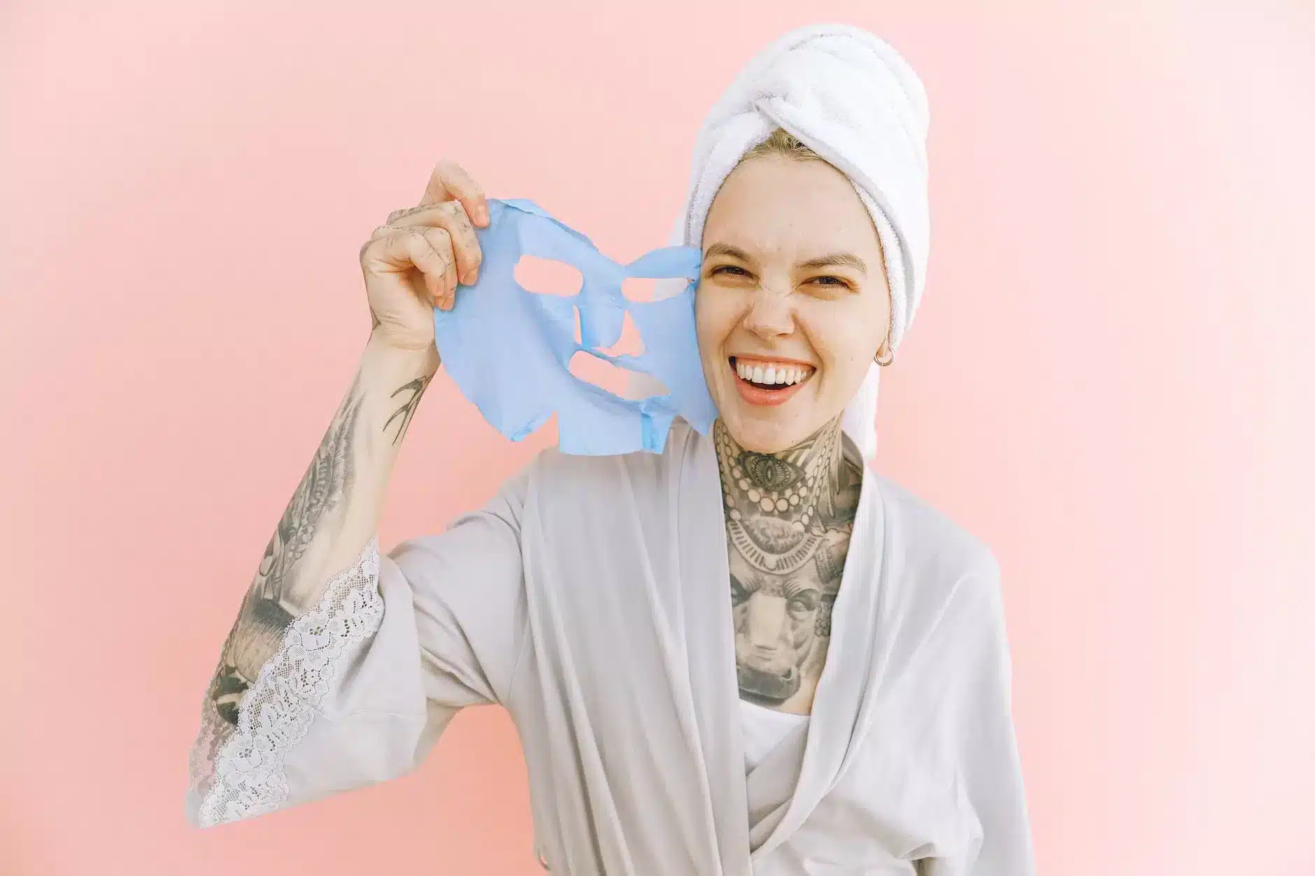 happy woman removing face mask after taking bath