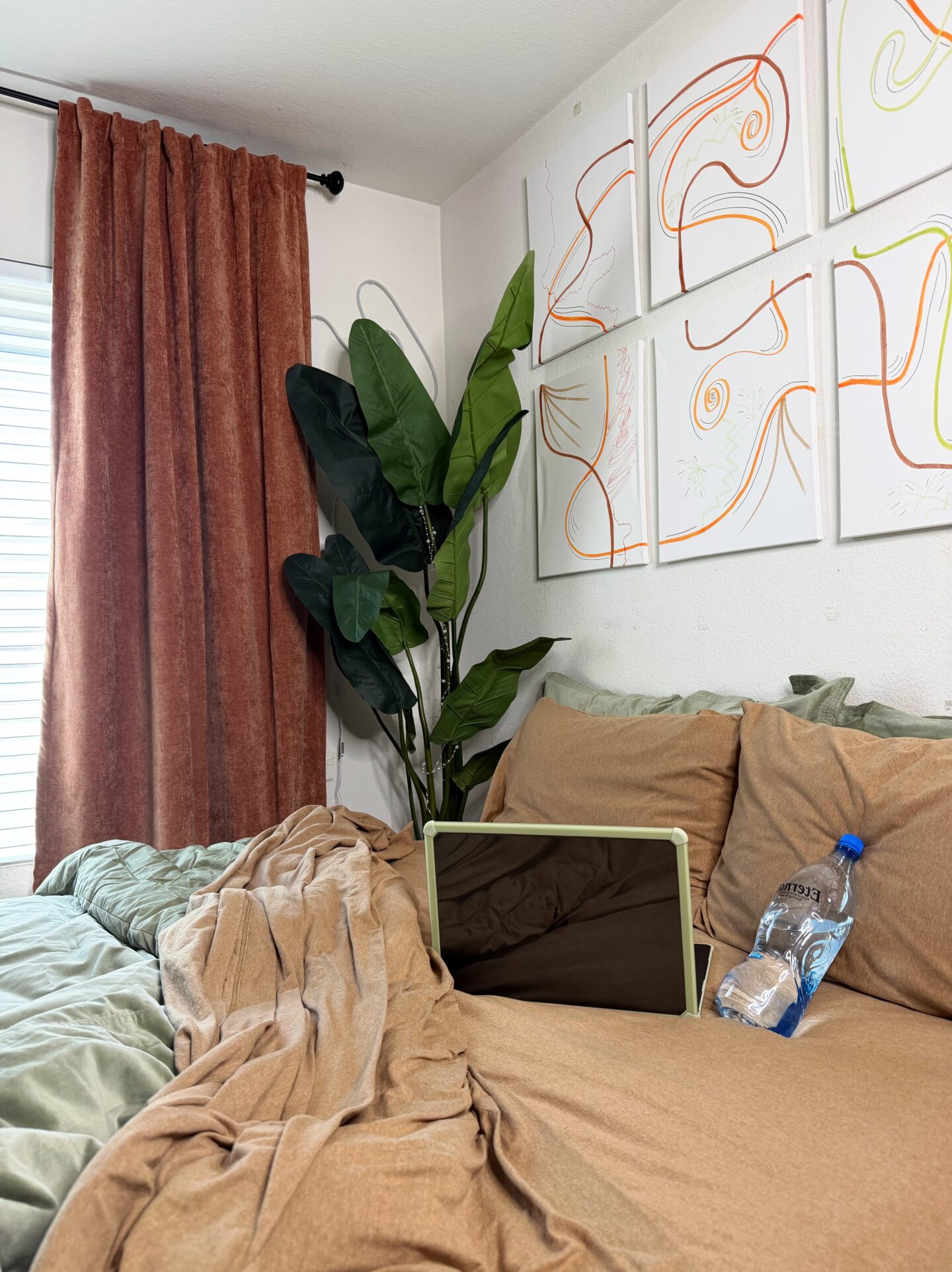 earth tone bedroom, sage green comforter, terracotta curtains, LA bedroom edit