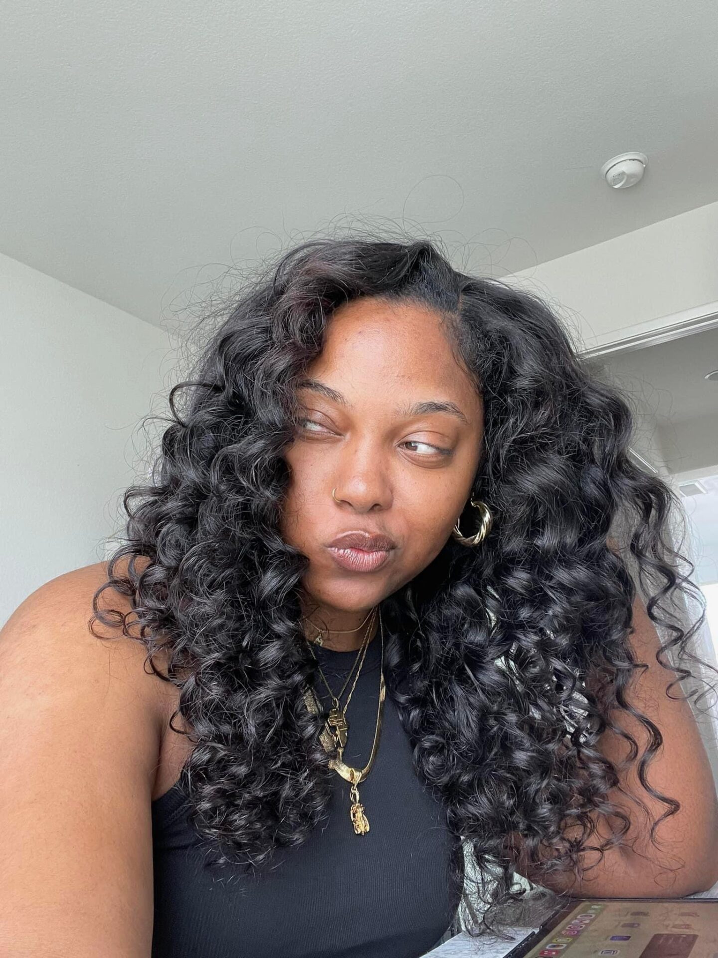 Morgan Ashley &mdash; natural skin, no makeup, curly hair, gold jewelry &mdash; skincare for melanin-rich skin at 40